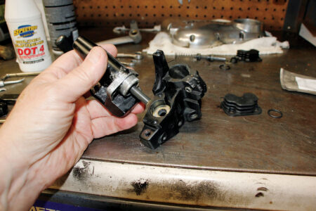 A hand reinstalling the master cylinder